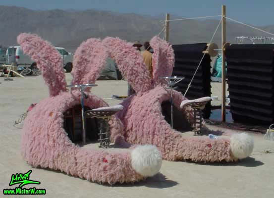 Photo of the giant electric powered Pink Bunny Slippers Mutant Vehicles / Art Cars in Black Rock City, Nevada, 2002. Electric Powered Pink Bunny Slippers