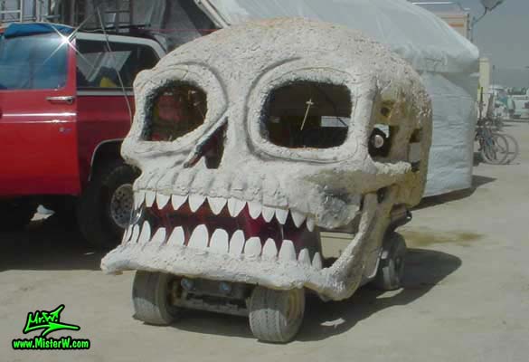 Photo of a white Skull Mutant Vehicle / Art Car in Black Rock City, Nevada, 2004. Skull Art Car