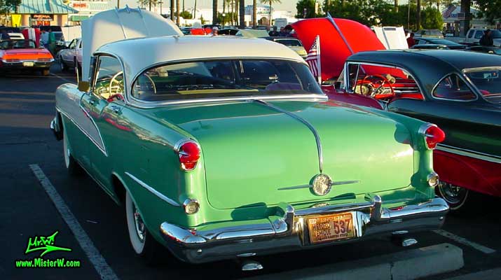 Photo of a white & turkquoise 1955 Oldsmobile 4 Door Hardtop Sedan at the Scottsdale Pavilions Classic Car Show in Arizona. 1955 Oldsmobile Fins