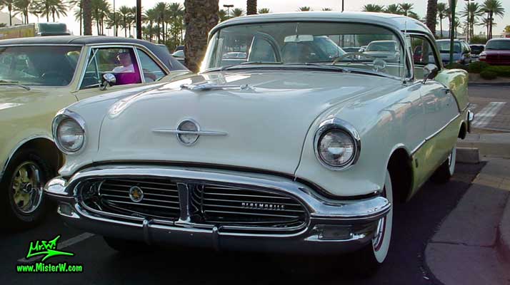 Photo of a white & yellow 1956 Oldsmobile 2 Door Hardtop Coupe at the Scottsdale Pavilions Classic Car Show in Arizona. 1956 Oldsmobile Coupe Sideview