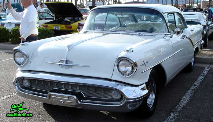 Photo of a white 1957 Oldsmobile 4 Door Hardtop Sedan at the Scottsdale Pavilions Classic Car Show in Arizona. 57 Olds Sedan