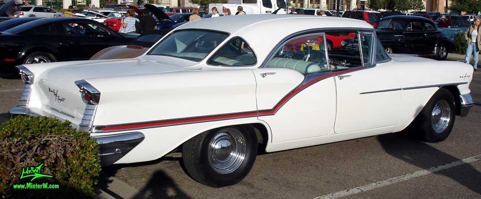 Photo of a white 1957 Oldsmobile 4 Door Hardtop Sedan at the Scottsdale Pavilions Classic Car Show in Arizona. 57 Olds Rearview