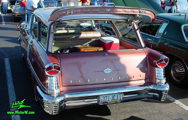 Photo of a pink 1957 Oldsmobile 4 Door Hardtop Station Wagon at the Scottsdale Pavilions Classic Car Show in Arizona. 57 Olds Wagon
