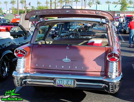 Photo of a pink 1957 Oldsmobile 4 Door Hardtop Station Wagon at the Scottsdale Pavilions Classic Car Show in Arizona. 1957 Oldsmobile Station Rearview