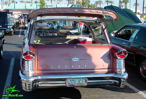 Photo of a pink 1957 Oldsmobile 4 Door Hardtop Station Wagon at the Scottsdale Pavilions Classic Car Show in Arizona. 1957 Oldsmobile Station Wagon Tail Lights