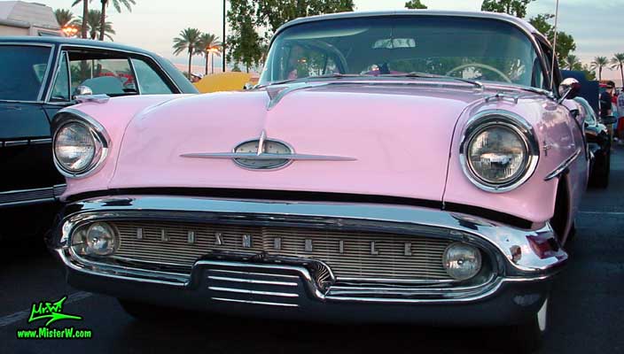 Photo of a pink 1957 Oldsmobile 2 Door Hardtop Coupe at the Scottsdale Pavilions Classic Car Show in Arizona. 57 Olds Coupe