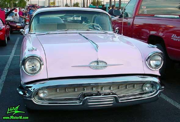 Photo of a pink 1957 Oldsmobile 2 Door Hardtop Coupe at the Scottsdale Pavilions Classic Car Show in Arizona. 1957 Oldsmobile Chrome Grill