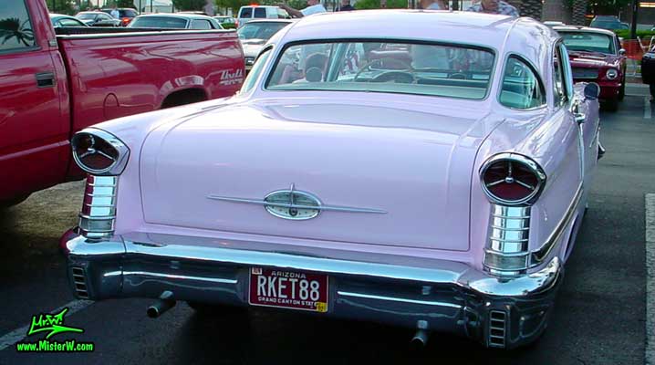 Photo of a pink 1957 Oldsmobile 2 Door Hardtop Coupe at the Scottsdale Pavilions Classic Car Show in Arizona. 1957 Oldsmobile Fins