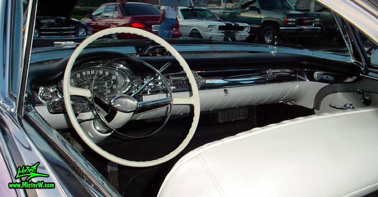 Photo of a pink 1957 Oldsmobile 2 Door Hardtop Coupe at the Scottsdale Pavilions Classic Car Show in Arizona. 1957 Oldsmobile Odometer & Dash Board