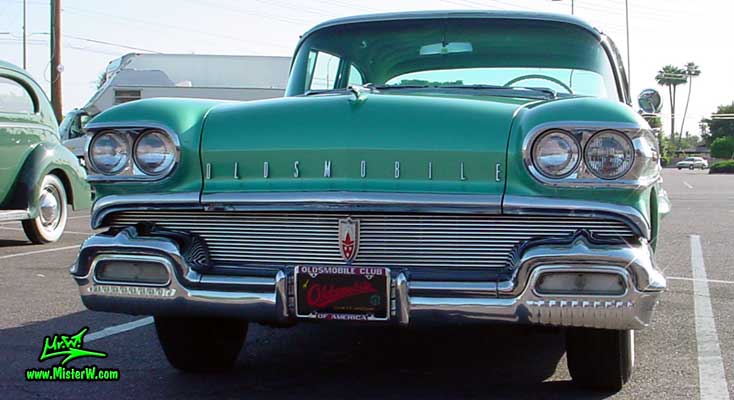 Photo of a green 1958 Oldsmobile 4 Door Hardtop Sedan at a Classic Car Meeting in Arizona. 1958 Oldsmobile 98 Front Bumper & Tons of Chrome