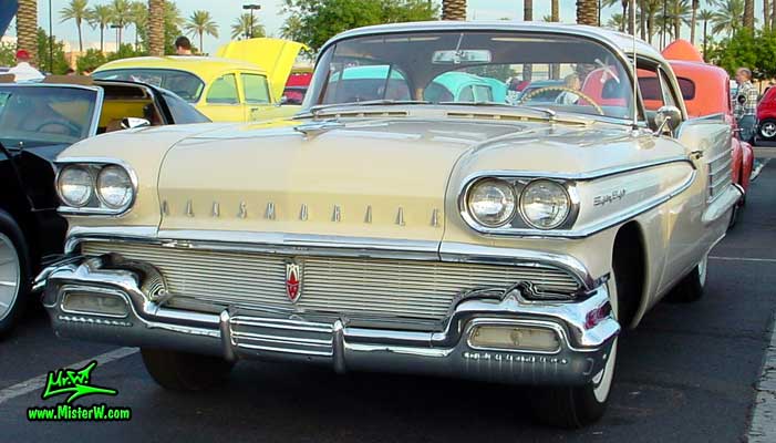 Photo of a beige 1958 Oldsmobile 2 Door Hardtop Coupe at the Scottsdale Pavilions Classic Car Show in Arizona. 58 Olds 88