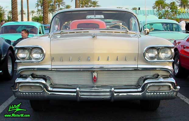 Photo of a beige 1958 Oldsmobile 2 Door Hardtop Coupe at the Scottsdale Pavilions Classic Car Show in Arizona. 1958 Oldsmobile Frontview