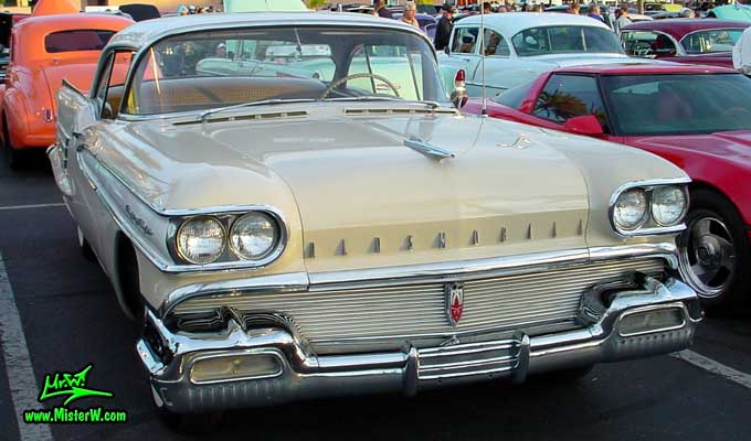 Photo of a beige 1958 Oldsmobile 2 Door Hardtop Coupe at the Scottsdale Pavilions Classic Car Show in Arizona. 58 Olds Eighty Eight Coupe