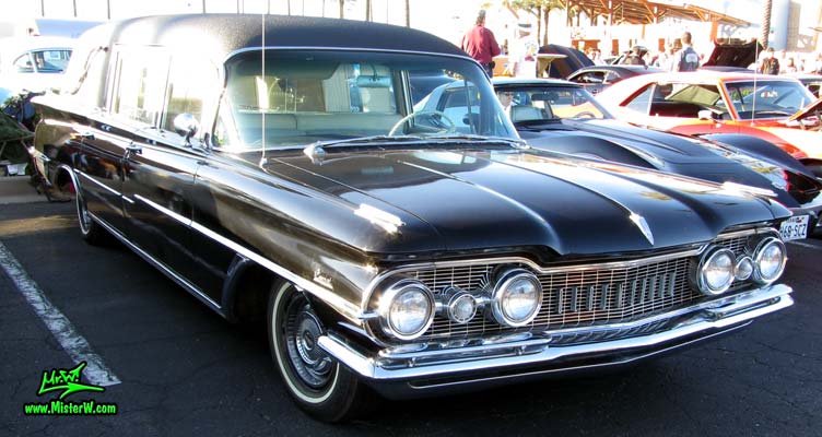 Photo of a black 1959 Oldsmobile Hearse at the Scottsdale Pavilions Classic Car Show in Arizona. 59 Olds Hearse