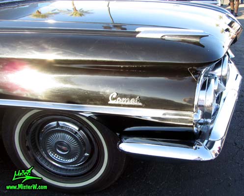 Photo of a black 1959 Oldsmobile Hearse at the Scottsdale Pavilions Classic Car Show in Arizona. Chrome Fender Ornament of a 1959 Oldsmobile Hearse