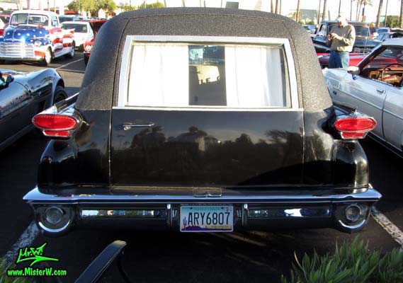 Photo of a black 1959 Oldsmobile Hearse at the Scottsdale Pavilions Classic Car Show in Arizona. Rearview of a 1959 Oldsmobile Hearse