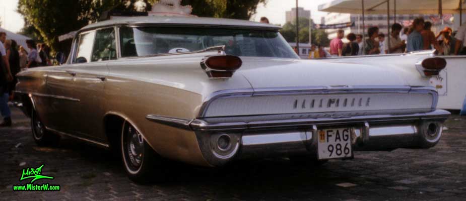 Photo of a white & brown 1959 Oldsmobile 4 Door Hardtop Sedan at a Classic Car Meeting in Germany. 59 Olds Tail Lights & Fins