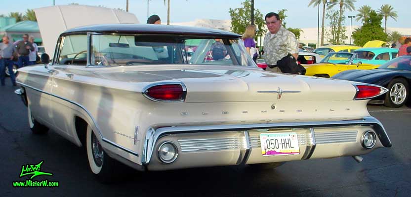 Photo of a white 1960 Oldsmobile 4 Door Hardtop Sedan at the Scottsdale Pavilions Classic Car Show in Arizona. 1960 Oldsmobile Tail Lights & Fins