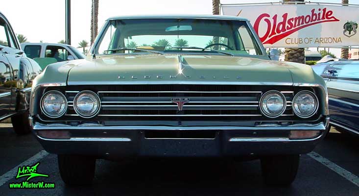 Photo of a olive 1964 Oldsmobile 2 Door Hardtop Coupe at the Scottsdale Pavilions Classic Car Show in Arizona. 1964 Oldsmobile Frontview