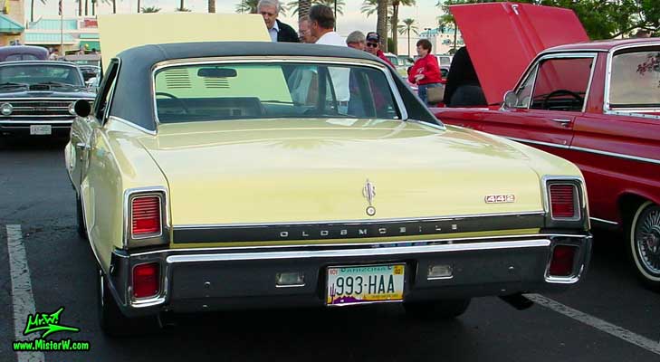 Photo of a yellow 1967 Oldsmobile 2 Door Hardtop Coupe at the Scottsdale Pavilions Classic Car Show in Arizona. 1967 Oldsmobile Rearview