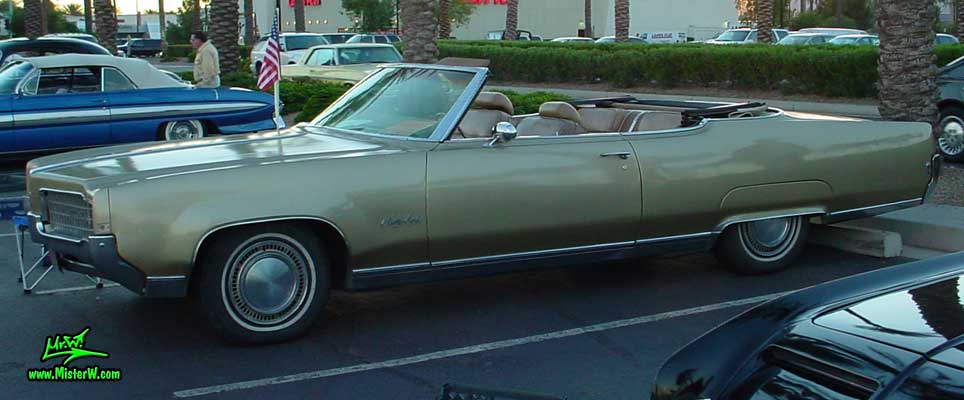 Photo of a gold 1969 Oldsmobile 2 Door Convertible at the Scottsdale Pavilions Classic Car Show in Arizona. 69 Olds