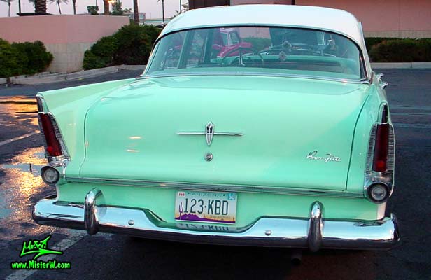 Photo of a white & turquoise 1956 Chrysler Plymouth Belvedere 4 Door Sedan at the Scottsdale Pavilions Classic Car Show in Arizona. Rearview of a 56 Plymouth Belvedere