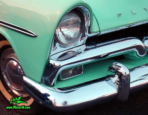Photo of a white & turquoise 1956 Chrysler Plymouth Belvedere 4 Door Sedan at the Scottsdale Pavilions Classic Car Show in Arizona. 1956 Plymouth Head Light