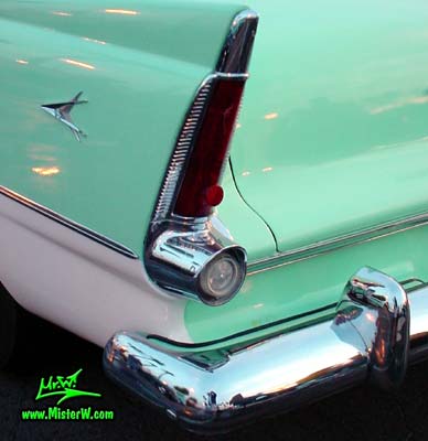 Photo of a white & turquoise 1956 Chrysler Plymouth Belvedere 4 Door Sedan at the Scottsdale Pavilions Classic Car Show in Arizona. Tail Light of a 56 Plymouth