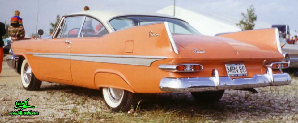 Photo of a salmon orange 1959 Chrysler Plymouth Belvedere 2 Door Hardtop Coupe at a classic car meeting in Germany. 1959 Plymouth Tail Fins