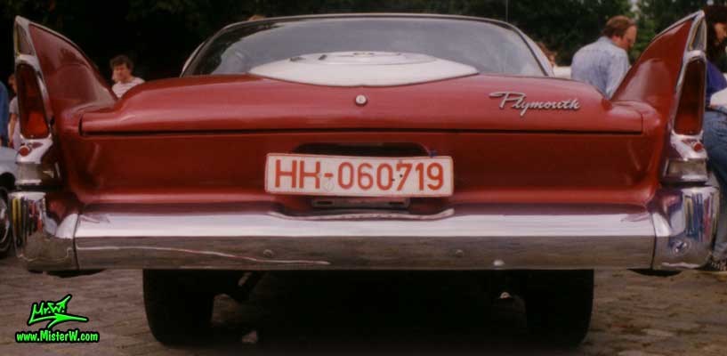 Photo of a dark red 1960 Chrysler Plymouth Fury 2 Door Hardtop Coupe at a classic car meeting in Germany. Back of a 1960 Plymouth Fury