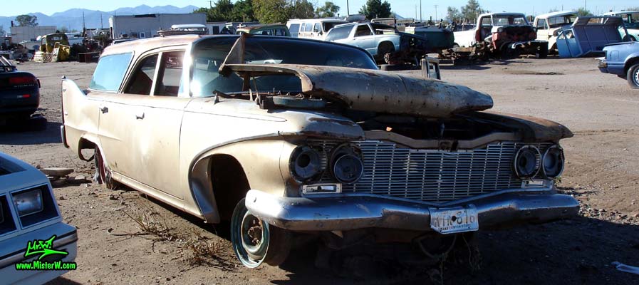 Photo of a 1960 Plymouth Custom Suburban 4 door 6 passenger station wagon at a junk yard in Phoenix, Arizona. Front view of a 1960 Plymouth Custom Suburban 4 door stationwagon