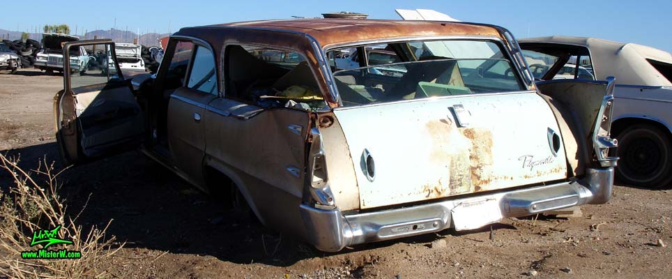 Photo of a 1960 Plymouth Custom Suburban 4 door 6 passenger station wagon at a junk yard in Phoenix, Arizona. Rear view of a 1960 Plymouth Custom Suburban 4 door stationwagon