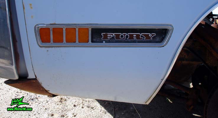 Photo of a white & rusty 1972 Chrysler Plymouth 2 door hardtop coupe at a junk yard in Phoenix, Arizona. 72 Plymouth Blinker & Fury Embleme