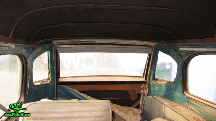 Photo of a grey primered 1956 Pontiac ambulance in Phoenix, Arizona. Rear windows of a 56 Pontiac Ambulance Wagon