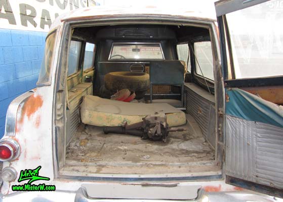 Photo of a grey primered 1956 Pontiac ambulance in Phoenix, Arizona. Open rear door of a 56 Pontiac Ambulance Wagon