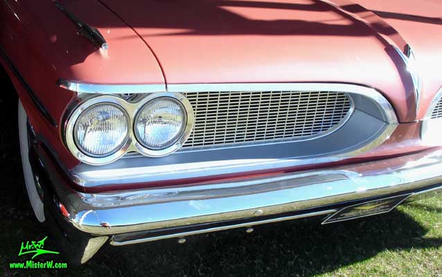 Photo of a pink 1959 Pontiac Star Chief 2 Door Hardtop Coupe at a Classic Car Auction in Scottsdale, Arizona. 59 Pontiac Head Lights & Chrome