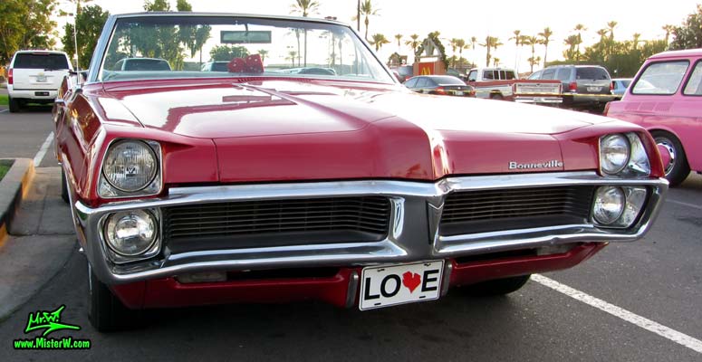 Photo of a red 1967 Pontiac Bonneville Convertible at the Scottsdale Pavilions Classic Car Show in Arizona. Beautiful Front Grill of a 67 Pontiac Bonneville Convertible