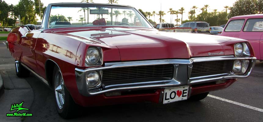 Photo of a red 1967 Pontiac Bonneville Convertible at the Scottsdale Pavilions Classic Car Show in Arizona. 67 Pontiac Agressive Front Grill