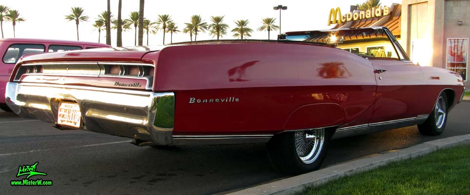 Photo of a red 1967 Pontiac Bonneville Convertible at the Scottsdale Pavilions Classic Car Show in Arizona. 1967 Pontiac Bonneville Convertible Coke Bottle Sidelines