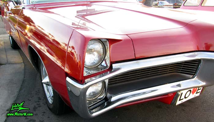 Photo of a red 1967 Pontiac Bonneville Convertible at the Scottsdale Pavilions Classic Car Show in Arizona. 1967 Pontiac Bonneville Convertible Head Lights