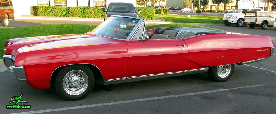 Photo of a red 1967 Pontiac Bonneville Convertible at the Scottsdale Pavilions Classic Car Show in Arizona. Coke bottle styling of a 67 Pontiac Bonneville Convertible
