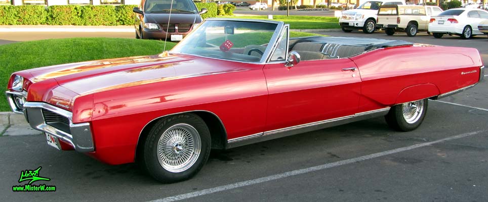 Photo of a red 1967 Pontiac Bonneville Convertible at the Scottsdale Pavilions Classic Car Show in Arizona. 1967 Pontiac Bonneville Convertible With Coke Bottle Style Sides