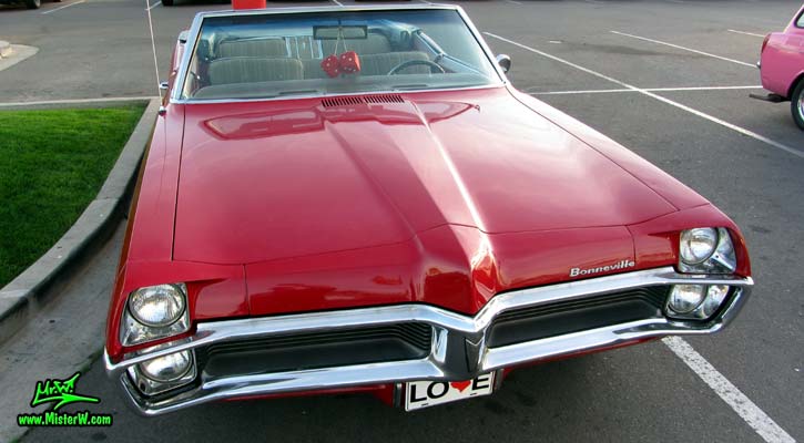 Photo of a red 1967 Pontiac Bonneville Convertible at the Scottsdale Pavilions Classic Car Show in Arizona. Front Nose of a 67 Pontiac Bonneville Convertible