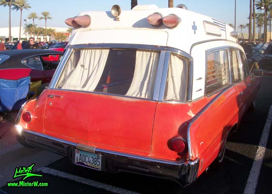 Photo of a red & white 1968 Pontiac Bonneville Ambulance at the Scottsdale Pavilions Classic Car Show in Arizona. Rearview of a 68 Pontiac Bonneville Ambulance