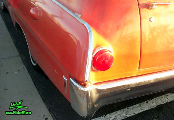 Photo of a red & white 1968 Pontiac Bonneville Ambulance at the Scottsdale Pavilions Classic Car Show in Arizona. Bumper Corner & Tail Light of a 68 Pontiac Bonneville Ambulance