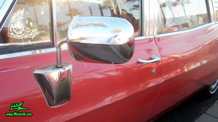 Photo of a red & white 1968 Pontiac Bonneville Ambulance at the Scottsdale Pavilions Classic Car Show in Arizona. Driver Side Mirror of a 68 Pontiac Bonneville Ambulance