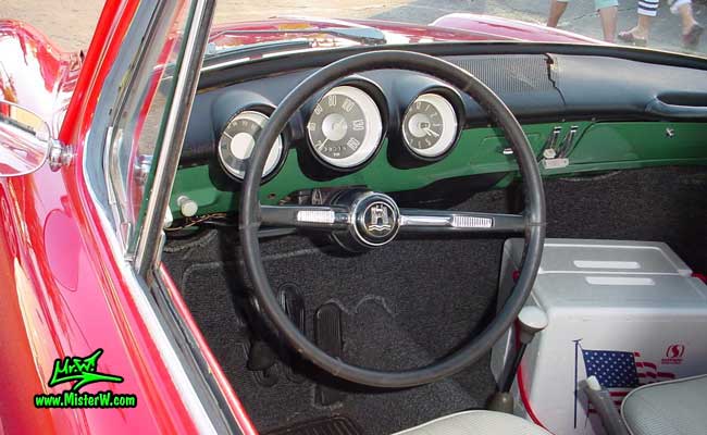 Photo of a red Volkswagen Type 3 Notchback Coupe at the Scottsdale Pavilions Classic Car Show in Arizona. Dashboard of a VW Notchback